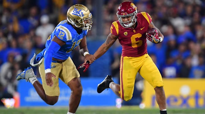 Southern California Trojans running back Austin Jones runs the ball against UCLA Bruins defensive lineman Grayson Murphy.
